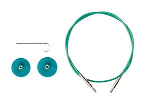Green circular knitting needles with two teal needle caps and a metal tool on a white background