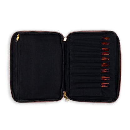Black zippered case with wooden knitting needles organized in individual slots, white background