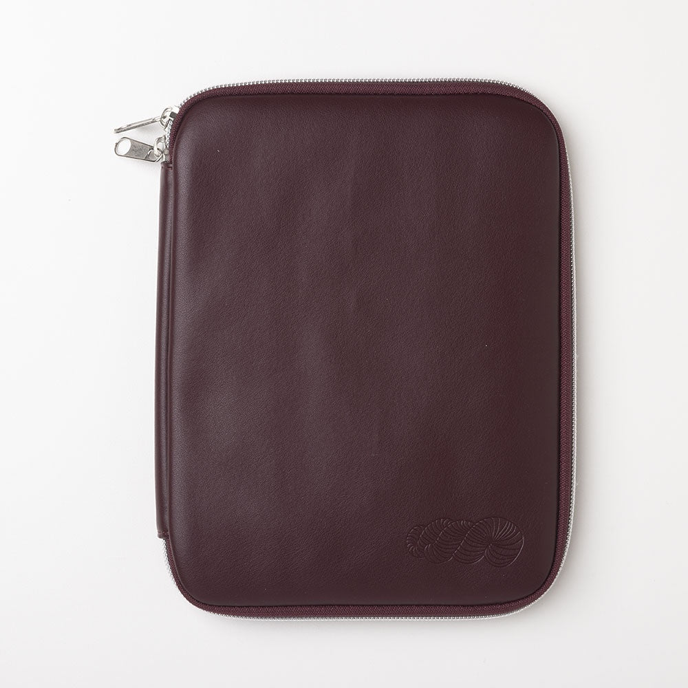 Brown leather zippered tablet or e-reader sleeve with embossed logo on white background